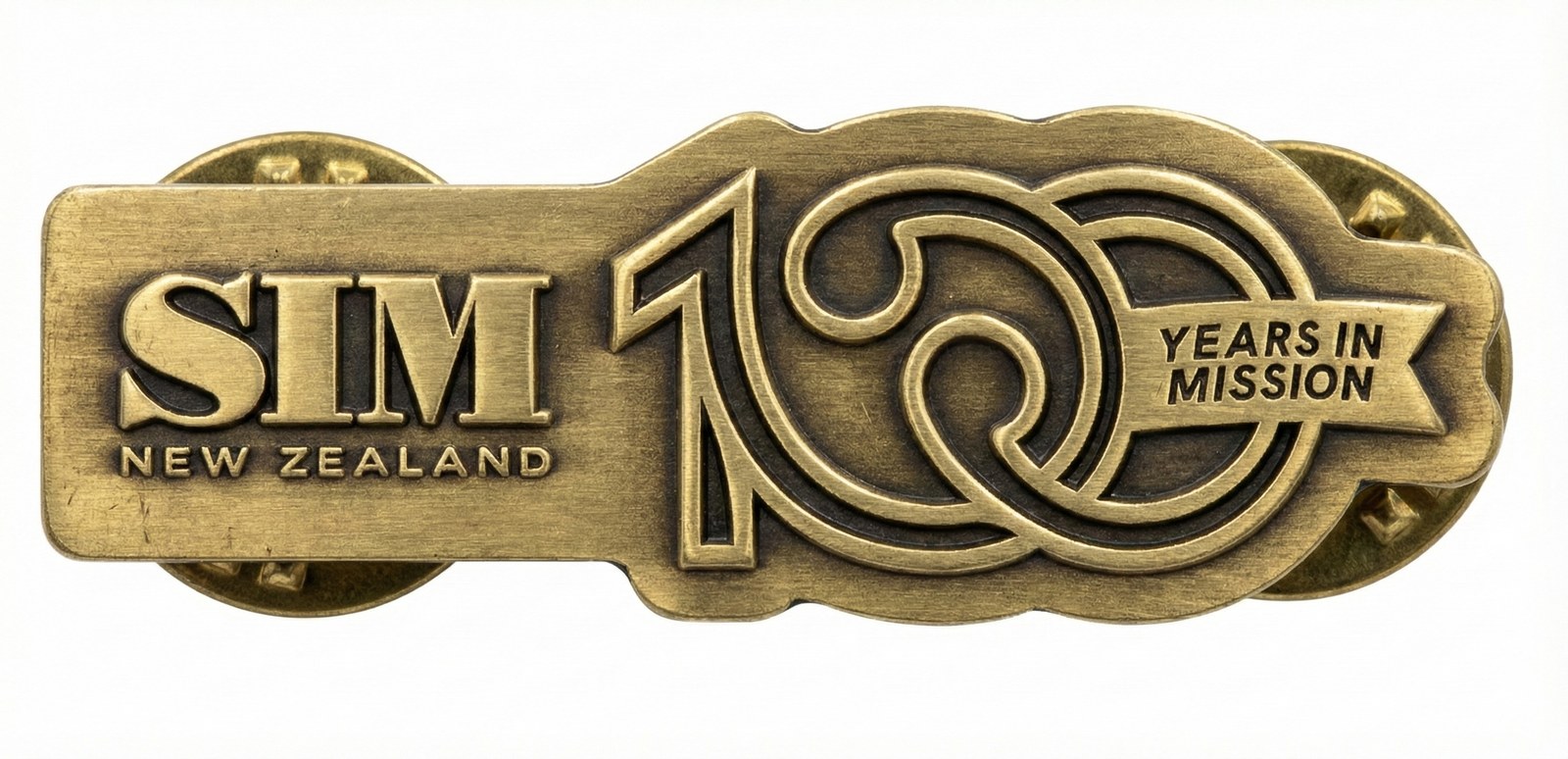 Antique brass lapel pin with SIM New Zealand and the 100 Years in Mission mark