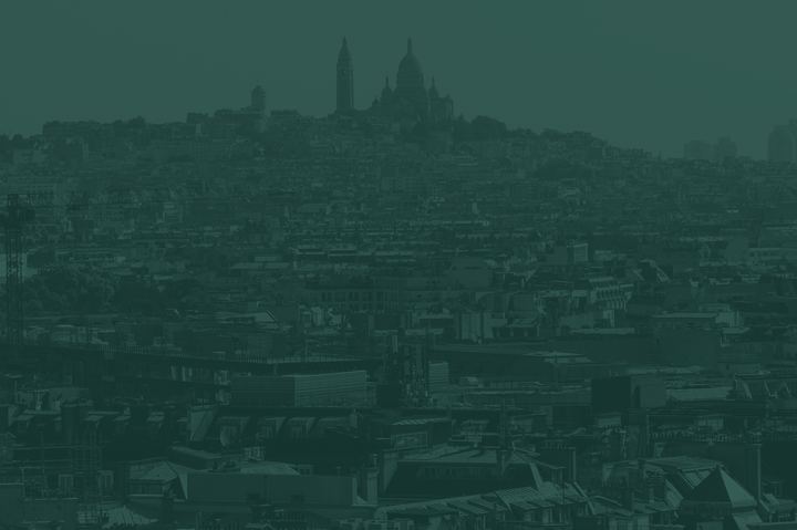 A city climbing a hill to a domed church, toned Pounamu green