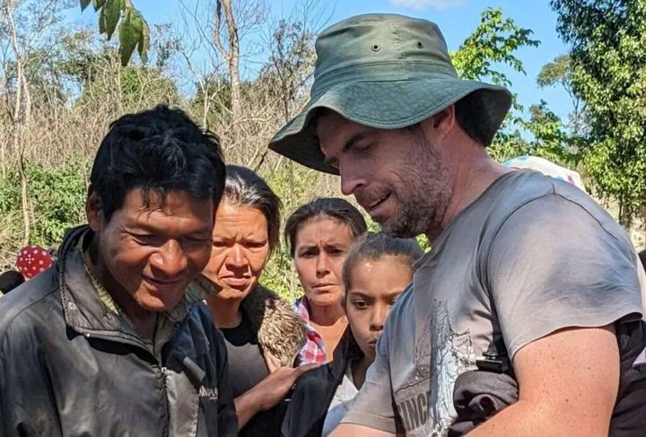 Two men talking outdoors in rural Paraguay